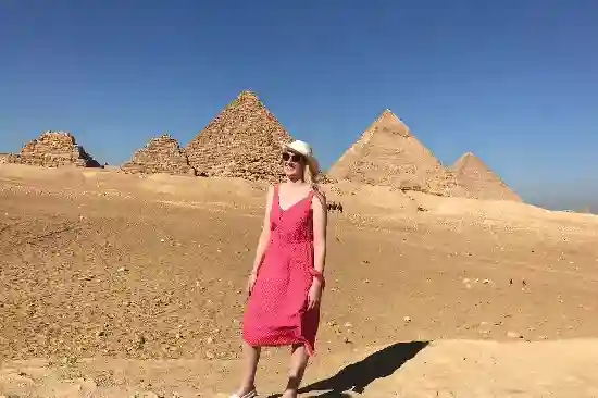 A woman enjoying the view of the Giza Pyramids on a private day trip.