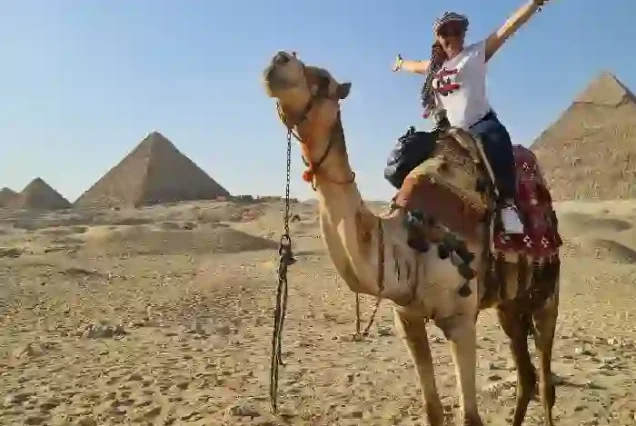 Camel riding at the Giza Pyramids during Cairo minibus trip.