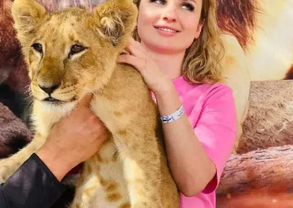 Woman holding a lion cub during baby lion Hurghada private safari tour