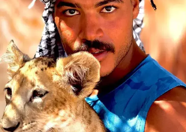 Man holding a lion cub during private baby lion Hurghada photo experience